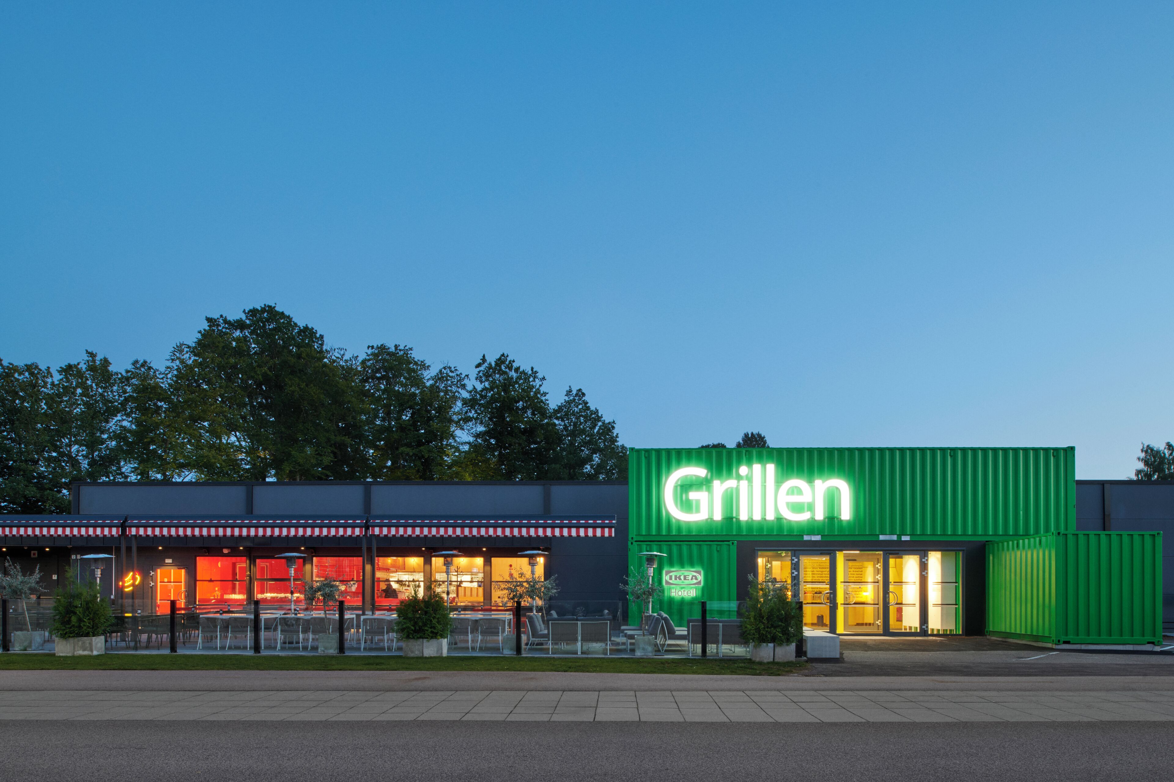 Un restaurante llamado Grillen con terraza y fachada verde.
