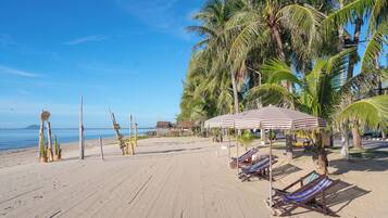 On the beach, sun-loungers, beach umbrellas, beach towels