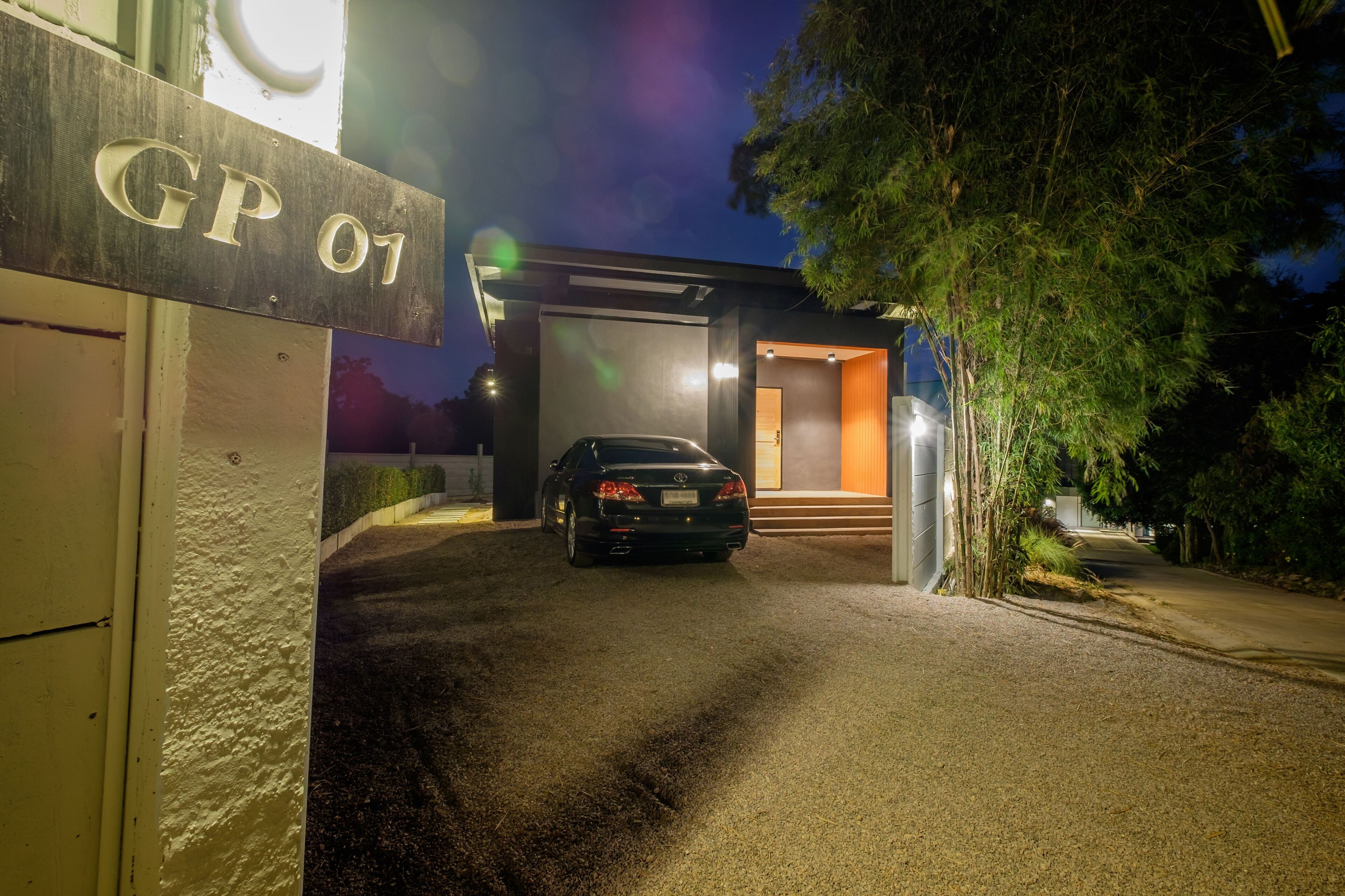 A modern building with a car parked in front.