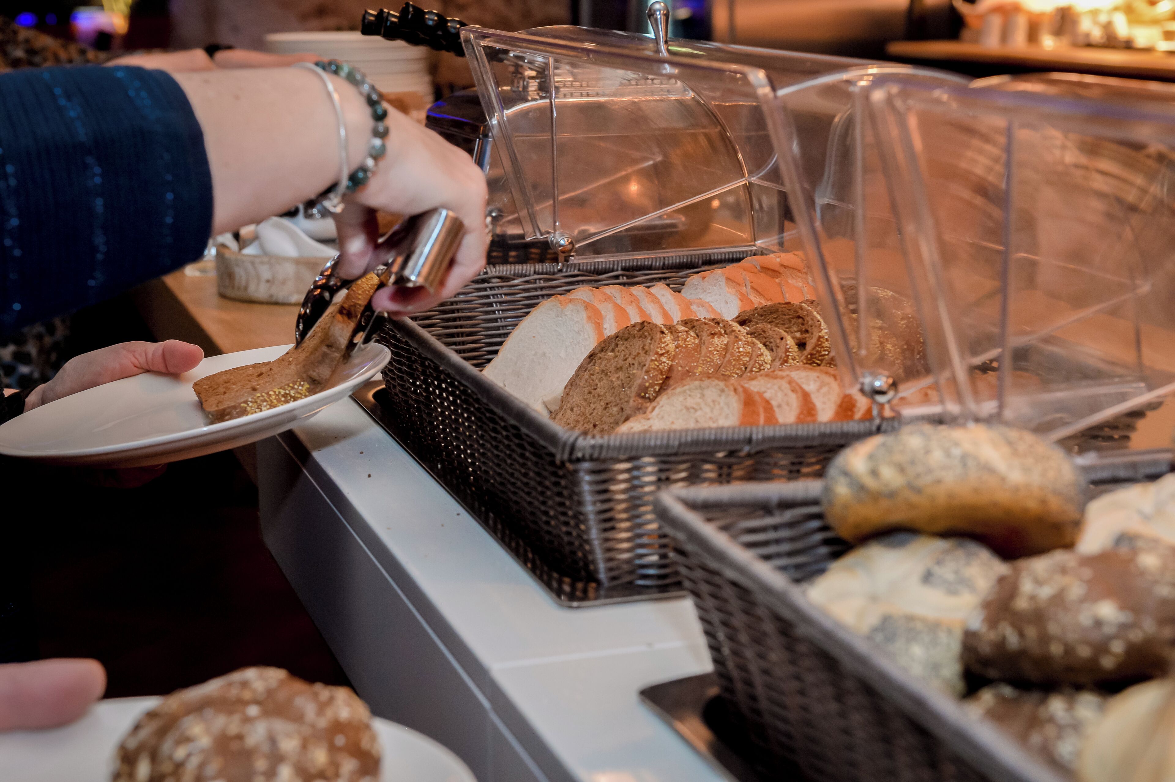 A bakery display with various breads and pastries.