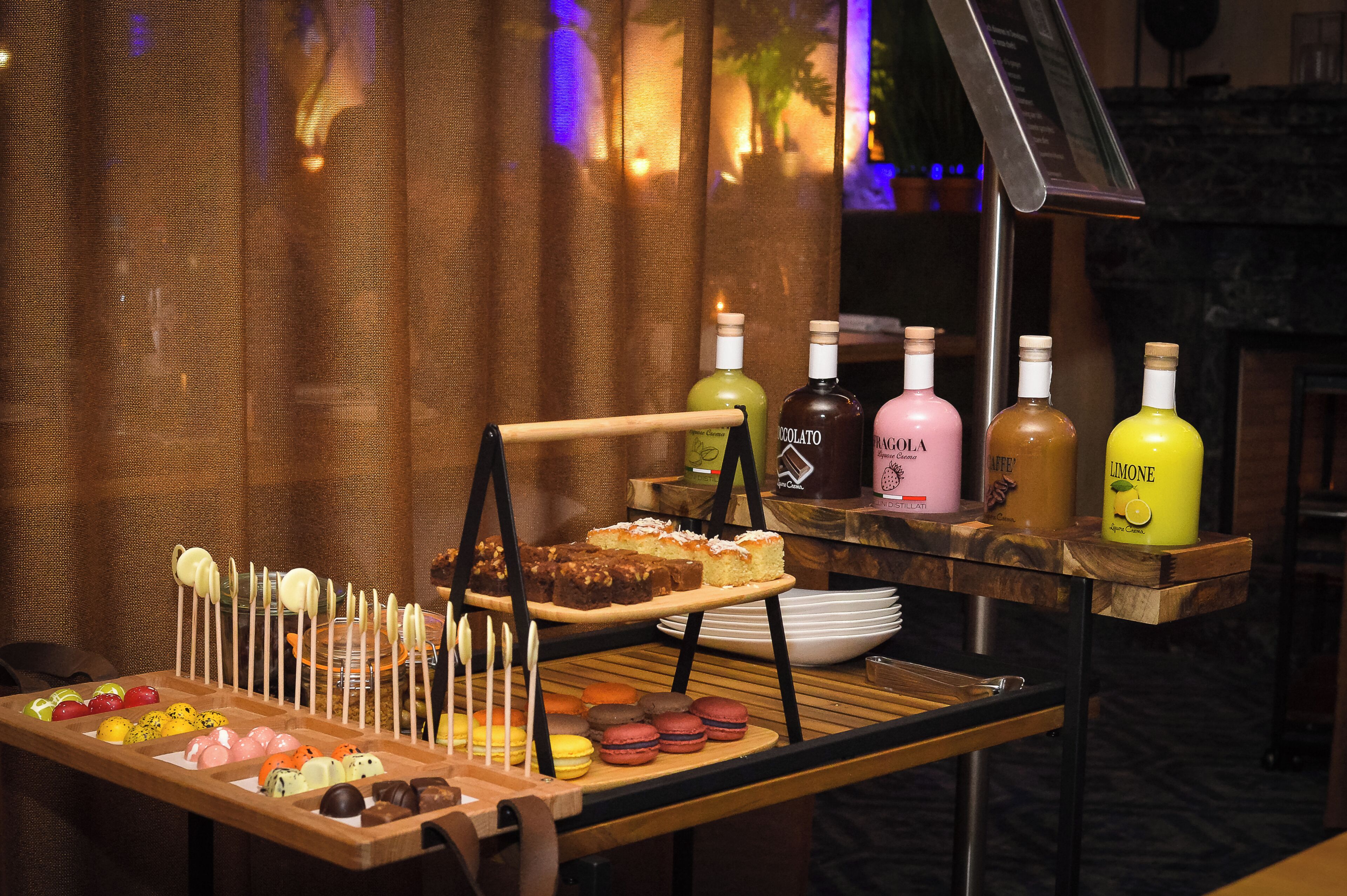 A buffet table with various desserts and beverages.