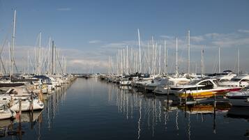 A marina with numerous boats docked along a calm waterway.