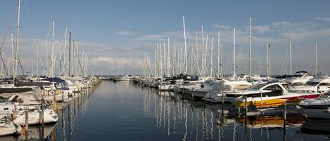 A marina with numerous boats docked along a calm waterway.