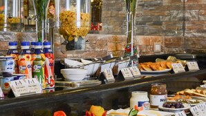 A buffet with various food items and beverages, including fruits, pastries, and condiments, with labels and price tags. - Mirita Hotel (Tenth of Ramadan City)