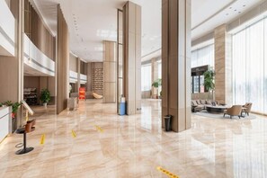 A spacious lobby with a high ceiling, a reception desk, seating area, and large windows. - Western Fortune Hotel Nanping (Nanping)