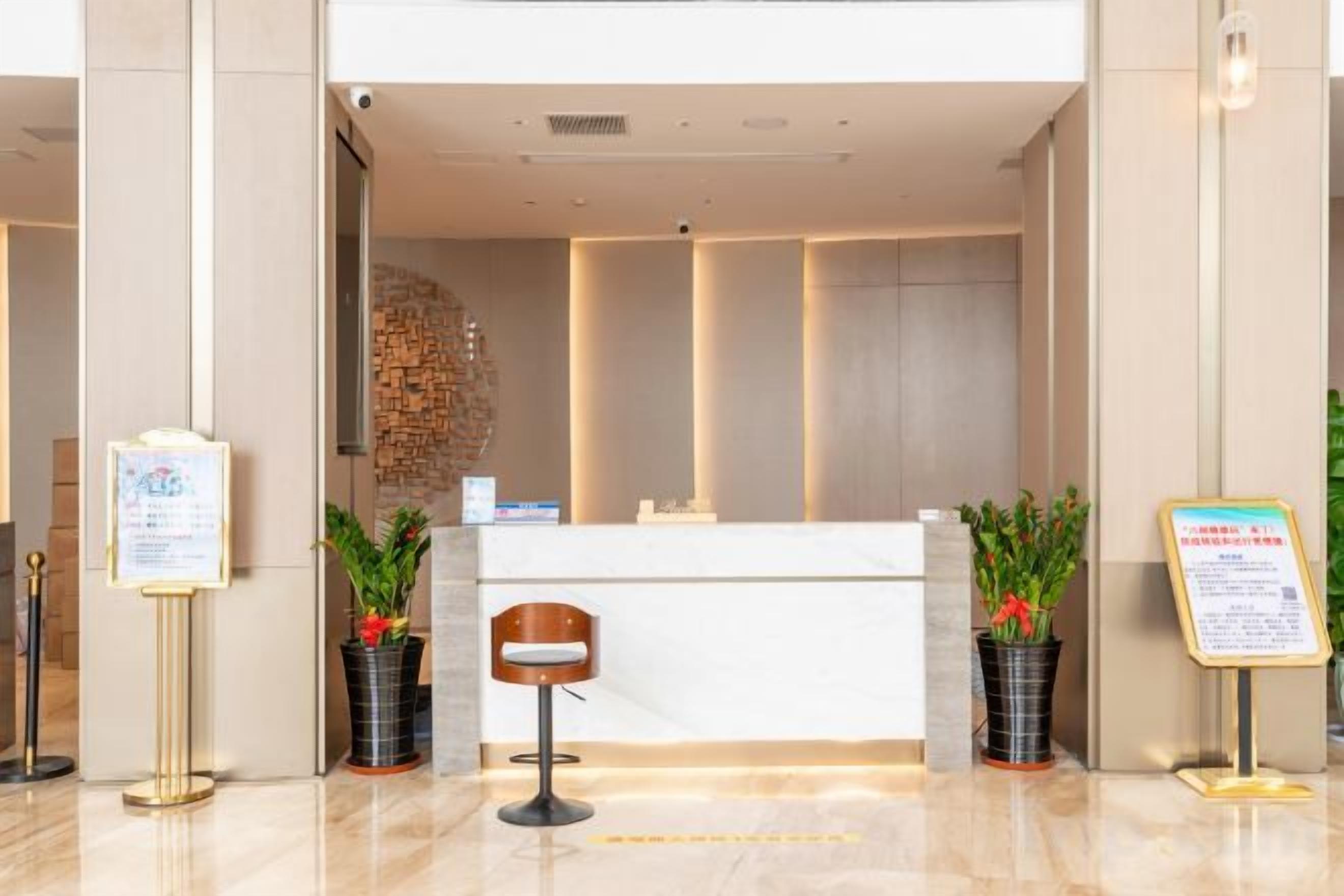 A reception area with a reception desk, a seating area, and informational signs.