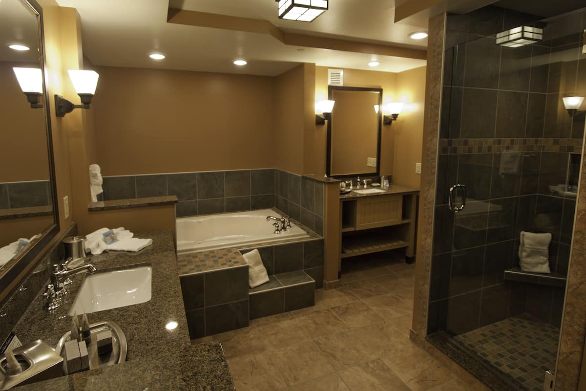 double queen village view jacuzzi suite | bathroom | shower, free toiletries, bathrobes, slippers