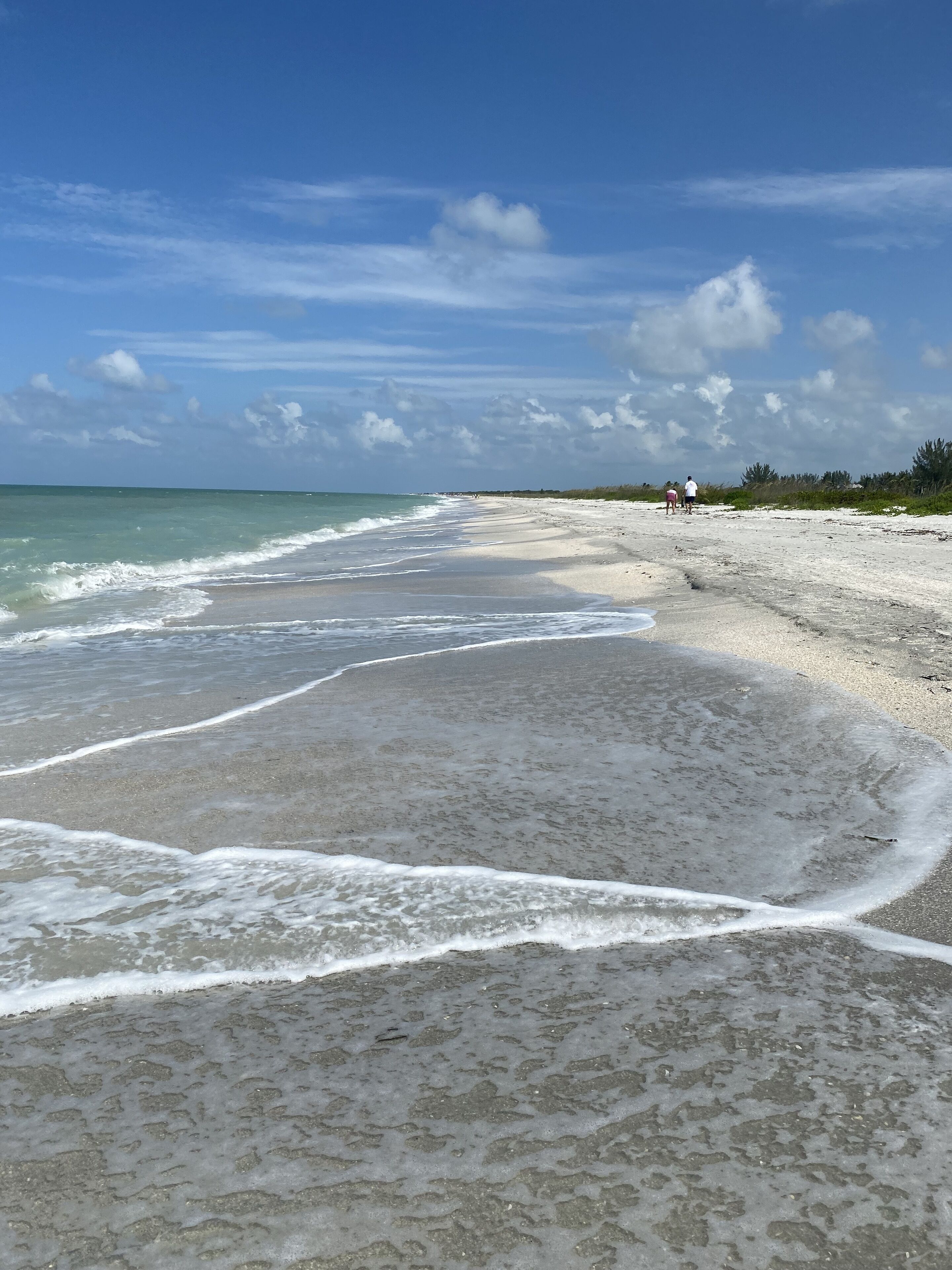 On the beach, white sand, beach umbrellas, beach towels