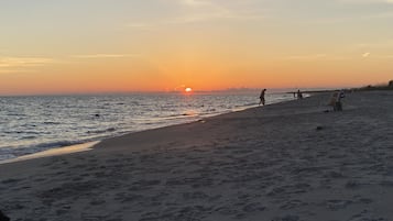 On the beach, white sand, beach umbrellas, beach towels