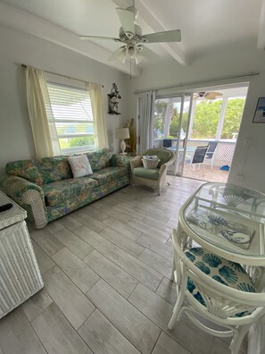 Ocean View Efficiency One Bedroom | Living area | TV - Tropical Winds Motel & Cottages (Sanibel)