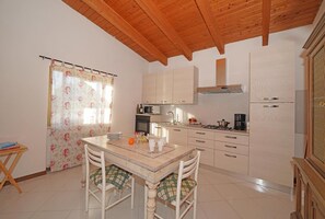 Full-sized fridge, microwave, stovetop, cookware/dishes/utensils