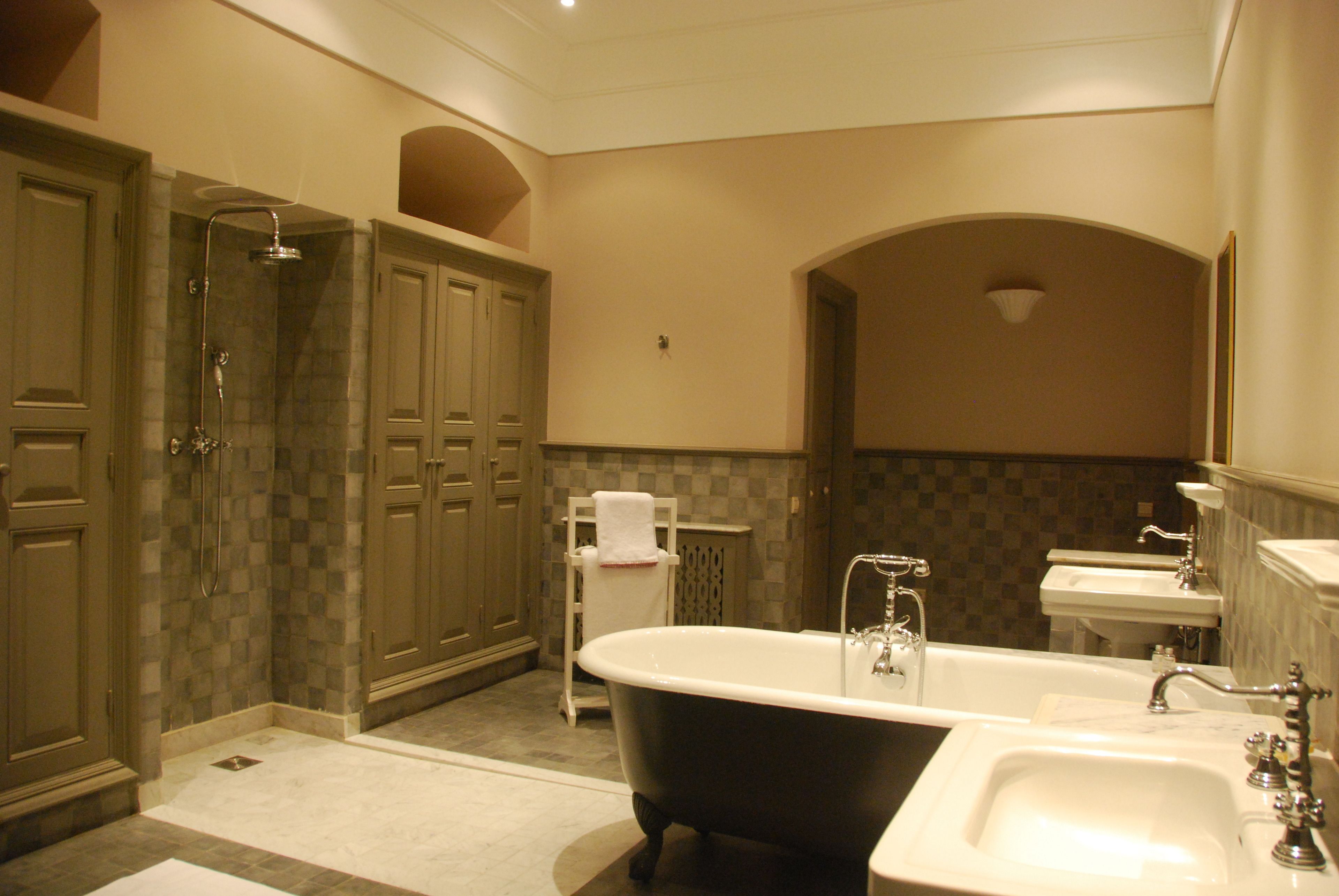 A bathroom with a freestanding bathtub, a shower, and a vanity with a sink.