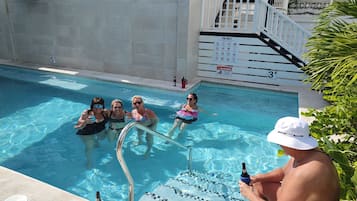 Outdoor pool, open 9:00 AM to 9:00 PM, pool loungers