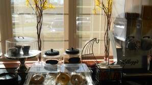 A bakery display with pastries and a coffee machine.