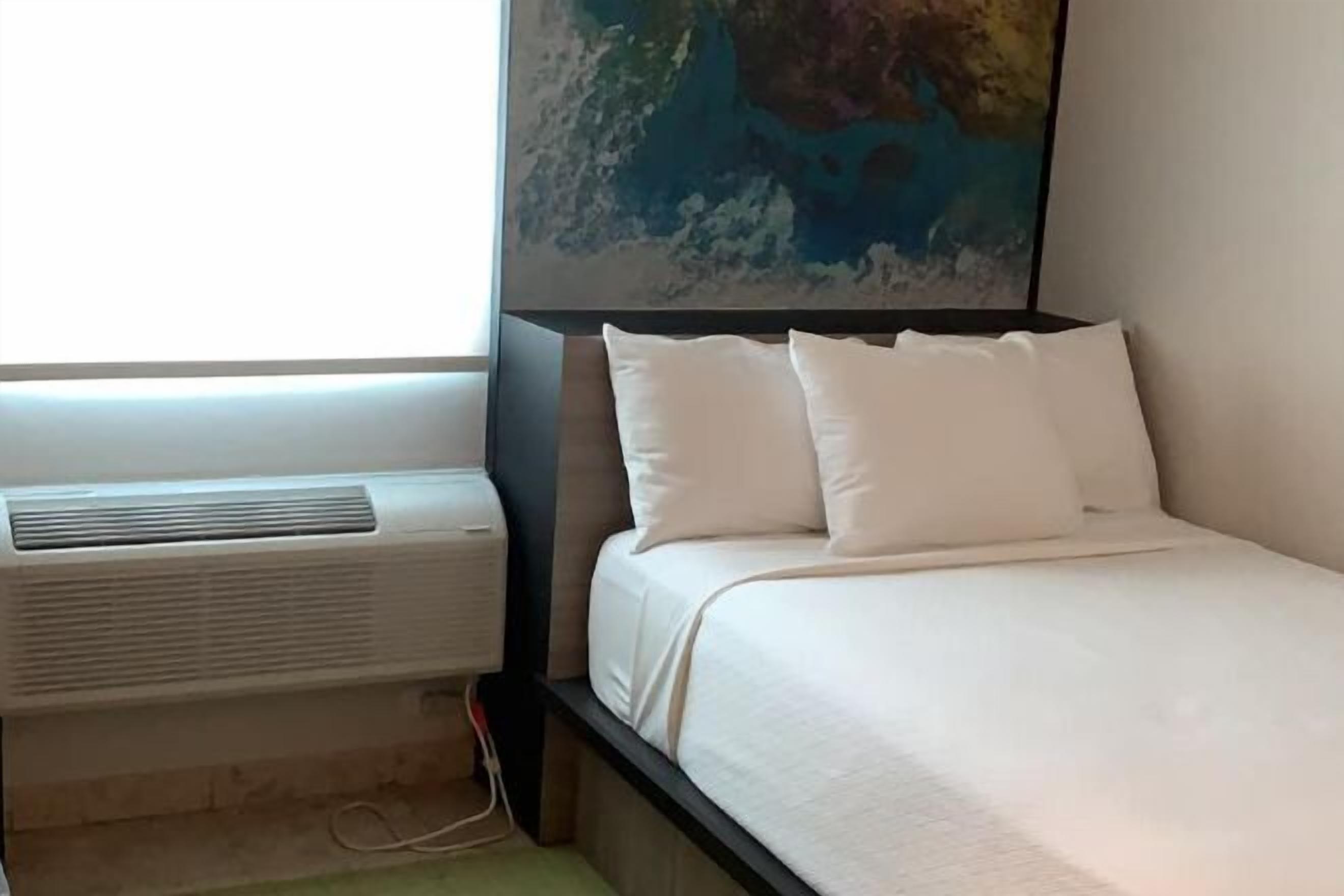 Premium bedding, pillow-top beds, blackout curtains, free WiFi