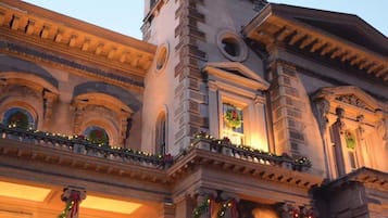 A historic building with classical architecture, featuring a prominent tower and ornate columns.