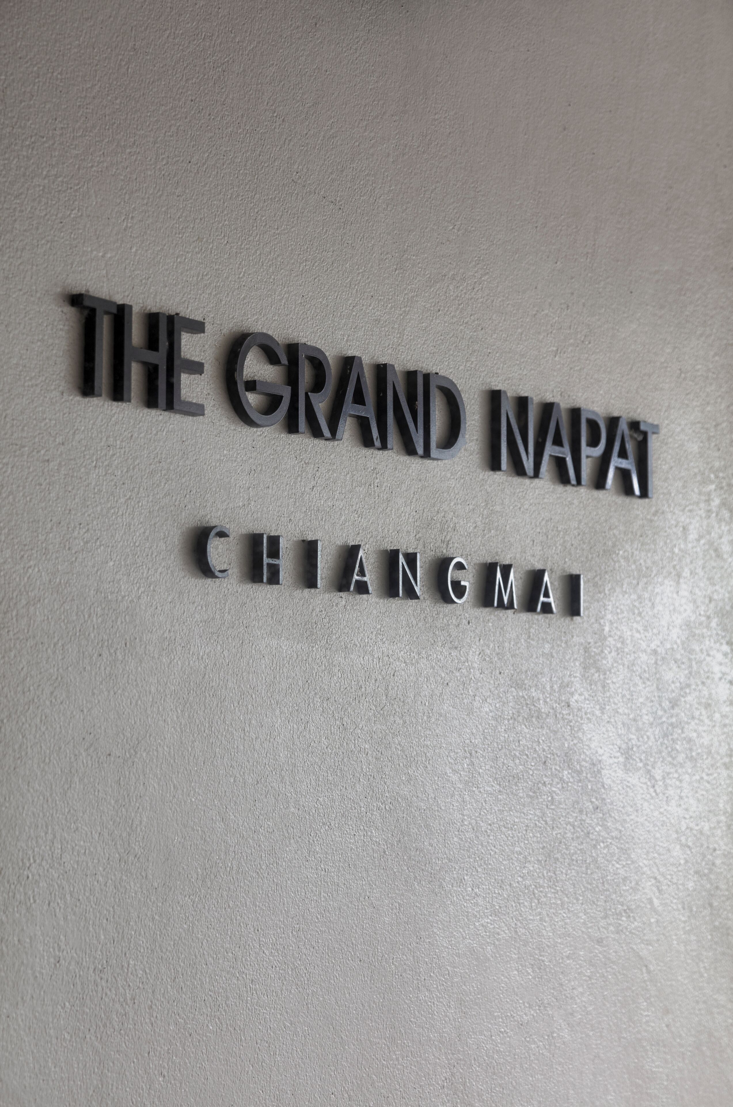 A sign with the text "THE GRAND INPAT CHANGMAI".