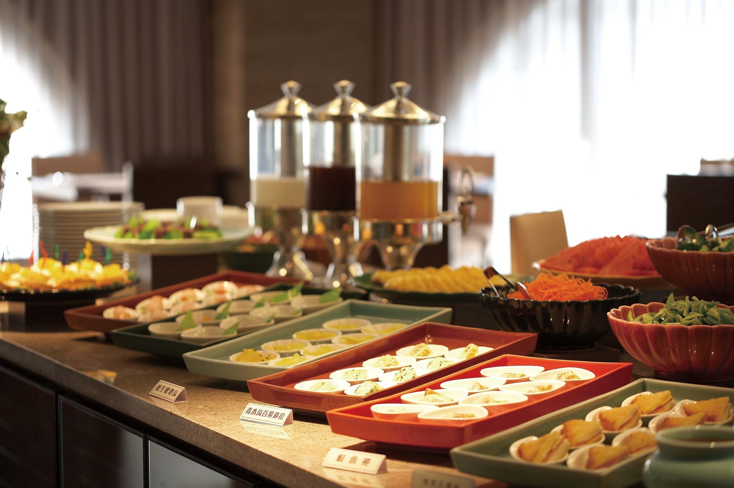 A buffet with various food items and containers.