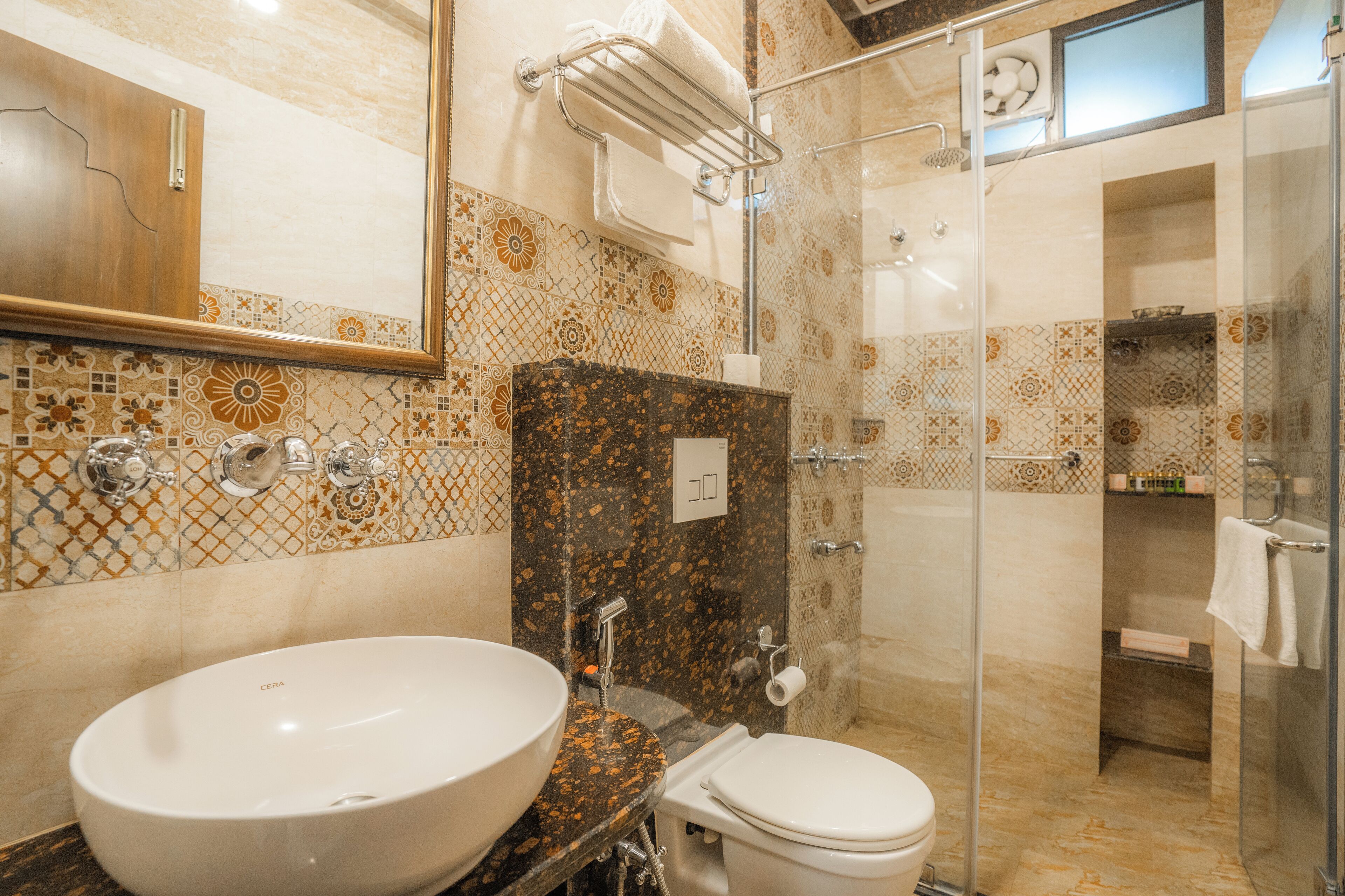 A bathroom with a large sink, toilet, and shower area.