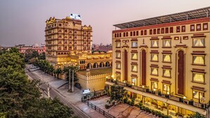A historic hotel with multiple stories, ornate architecture, and a well-lit facade. - Umaid Residency - A Regal Heritage Home (Amer)
