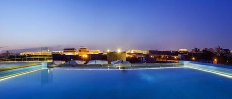 Seasonal outdoor pool, open 7:30 AM to 10 PM, pool umbrellas