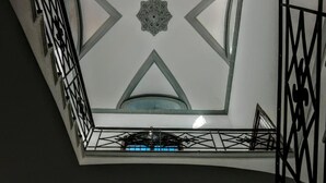 A high-ceilinged interior with geometric patterns and a skylight. - B&B Carella (Palermo)