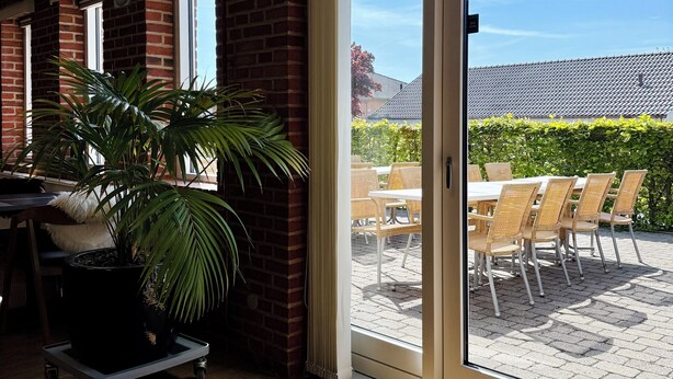 A hotel room with a sliding glass door leading to an outdoor patio area. - Hotel Korning B&B  (Horsens)
