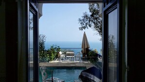 An open door leading to a pool area with two chairs and an umbrella. - La Villa Bleue (Sidi Bou Said)