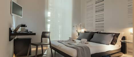A modern bedroom with a bed, desk, chair, and a wall with text and numbers.