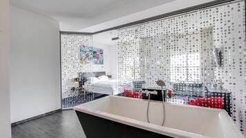 A modern bathroom with a freestanding bathtub, a shower area, and a large mirror.