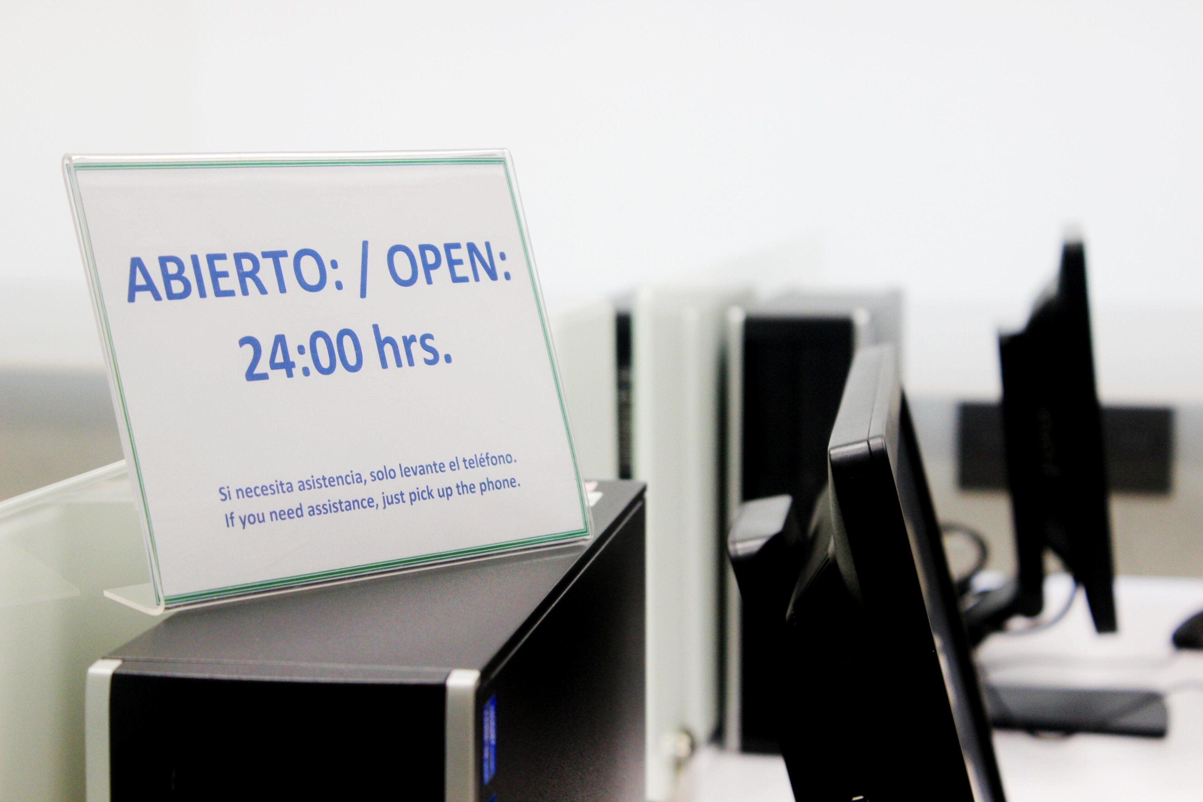 A sign indicating the business hours as open 24 hours.