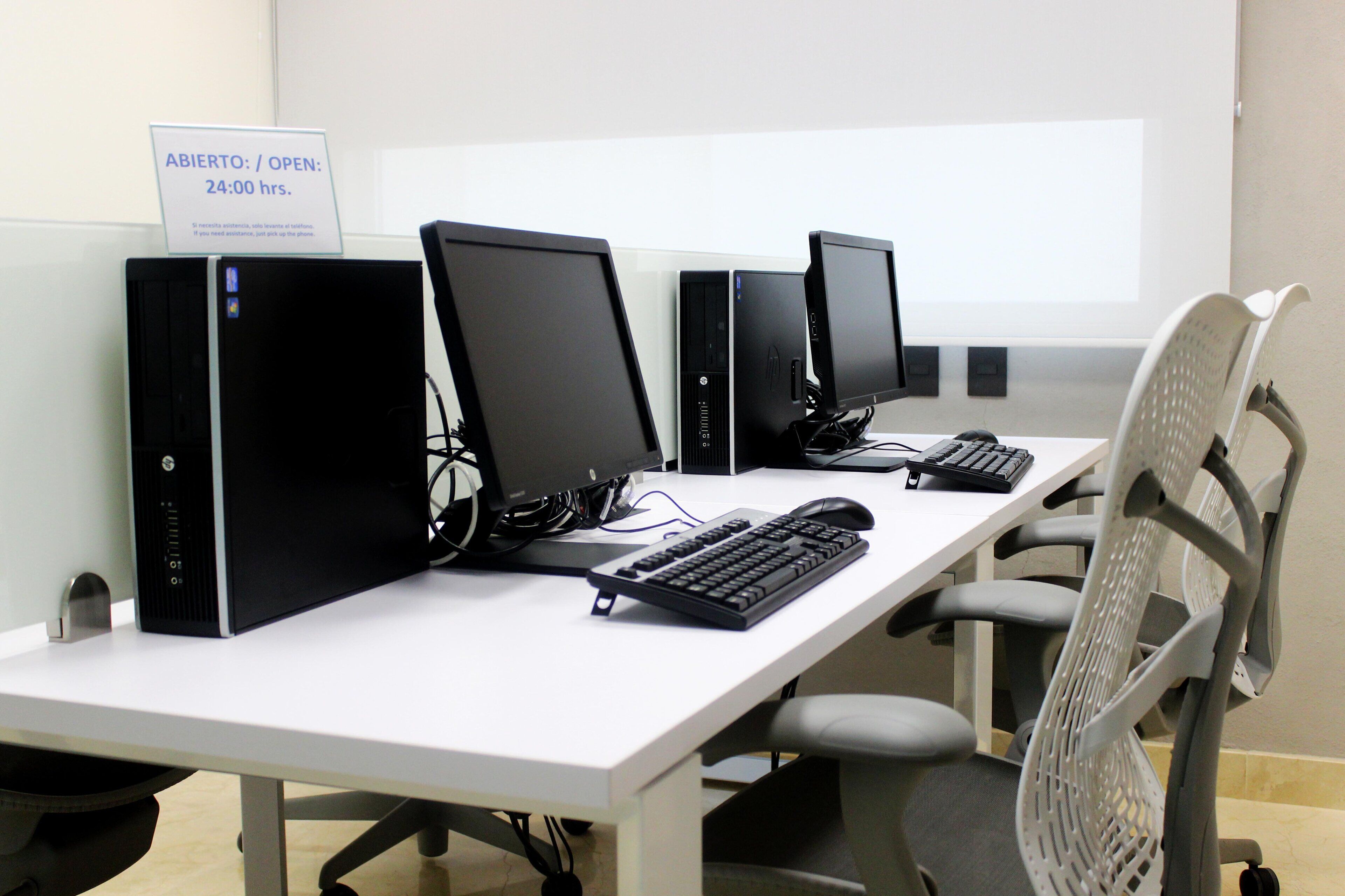 A computer lab with multiple workstations, each equipped with a monitor, keyboard, and mouse.