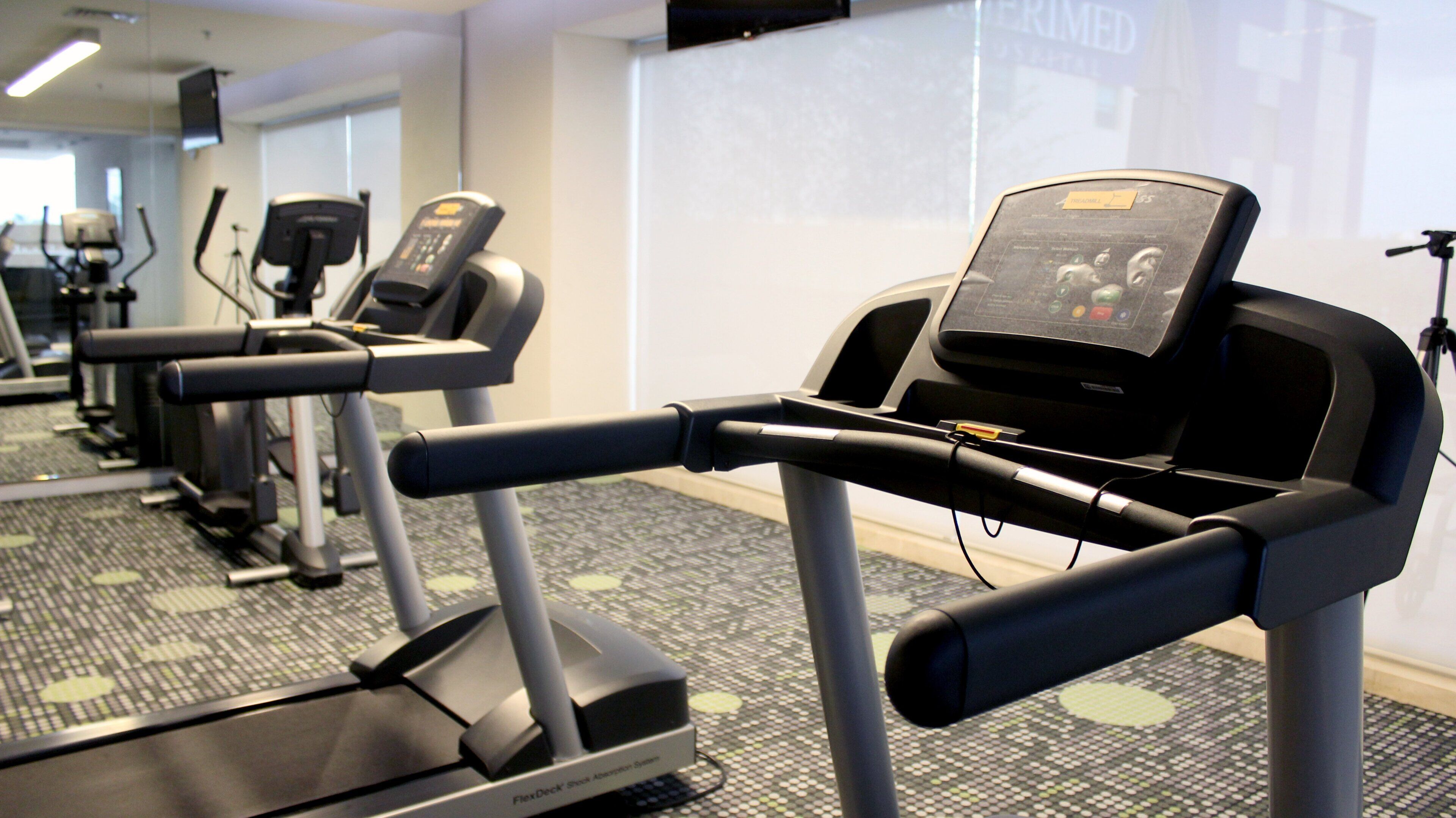 A gym with treadmills and exercise equipment.