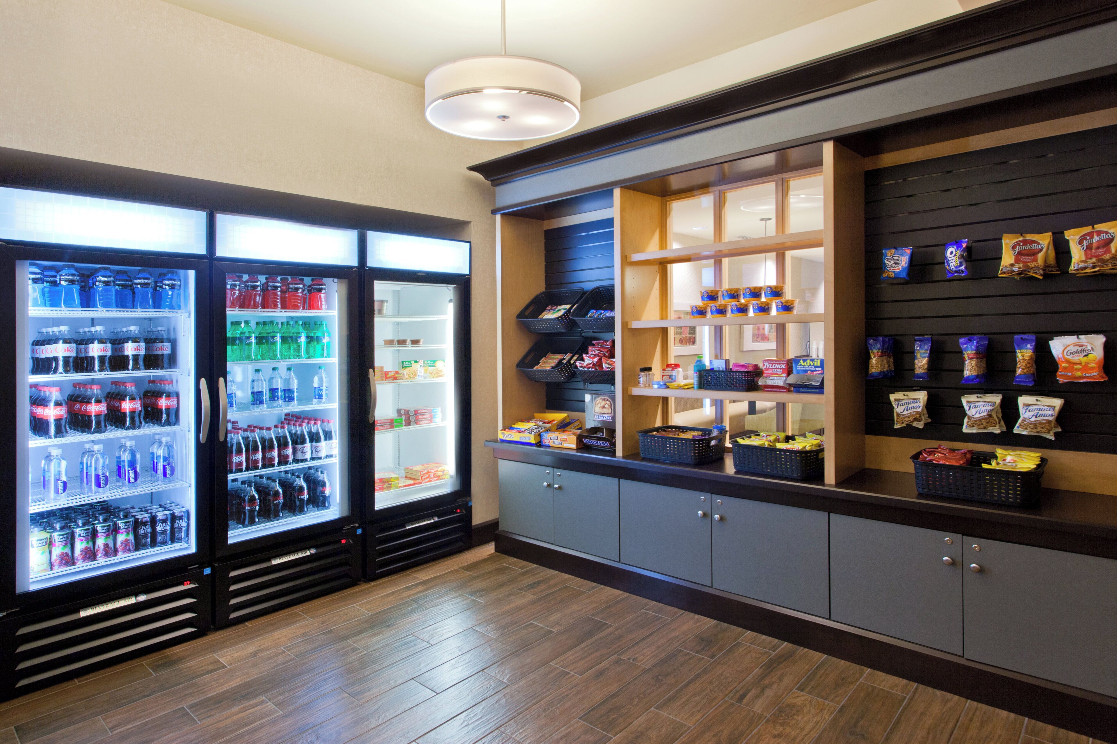 A vending area with various snacks and drinks, including a refrigerator stocked with beverages.