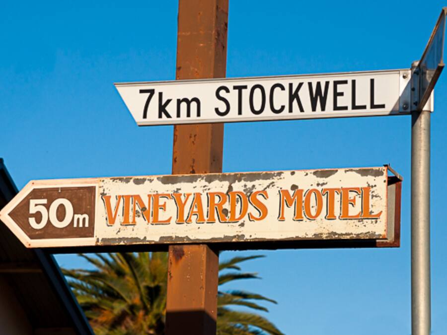 A directional sign with "7km STOCKWELL" and "50m VINEYARDS MOTEL" pointing in different directions.