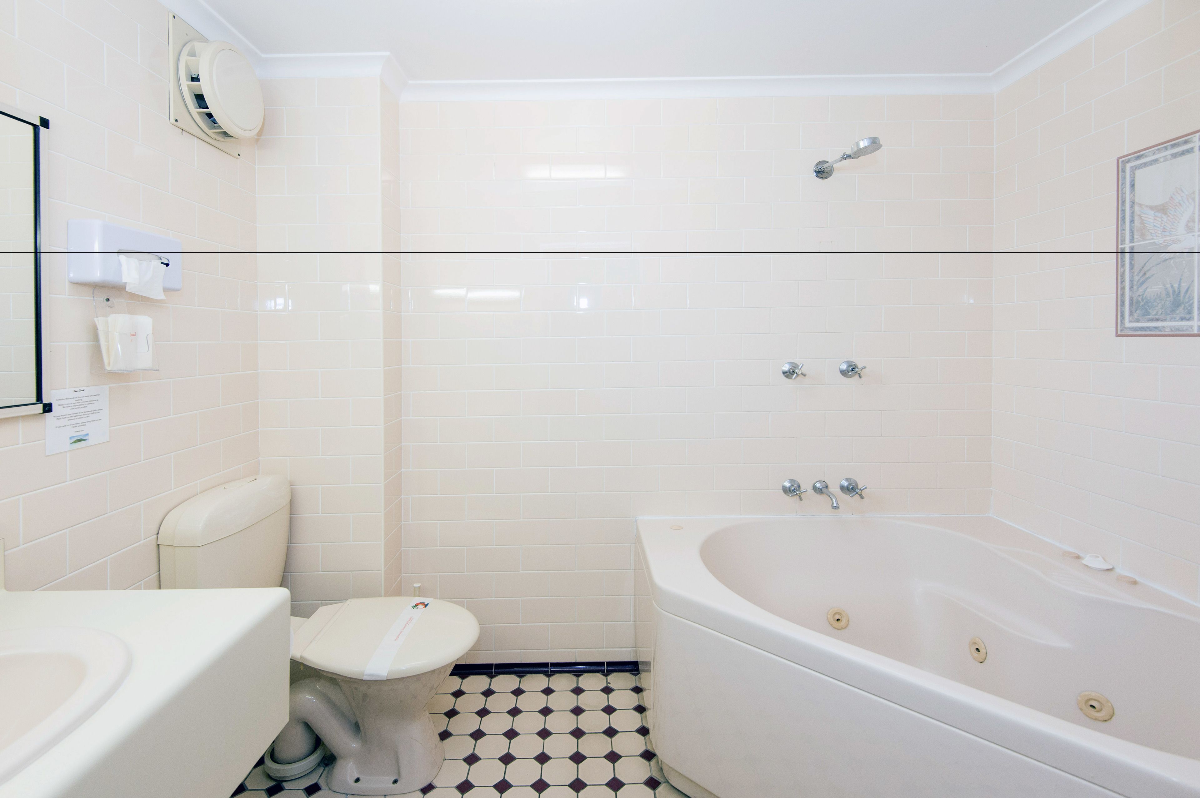 A bathroom with a toilet, sink, bathtub, and shower.