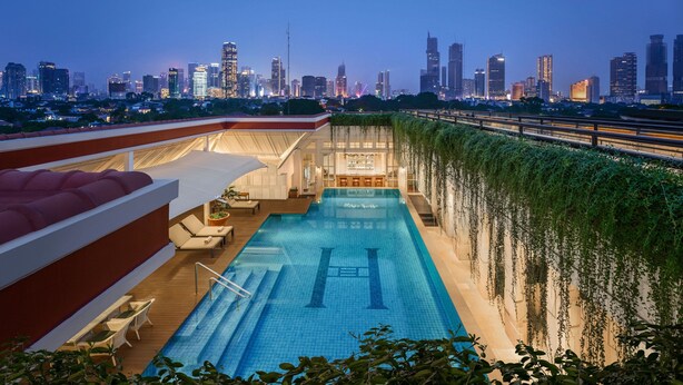 A rooftop pool with a city skyline view, a covered seating area, and a modern architectural design. - The Hermitage, A Tribute Portfolio Hotel, Jakarta (Jakarta)