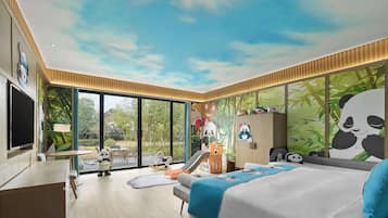 A modern hotel room with a large bed, a desk, and a TV.