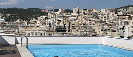 Seasonal outdoor pool, open 10 AM to 7 PM, pool umbrellas, pool loungers