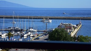 Un puerto deportivo con barcos amarrados, un muelle y un faro.