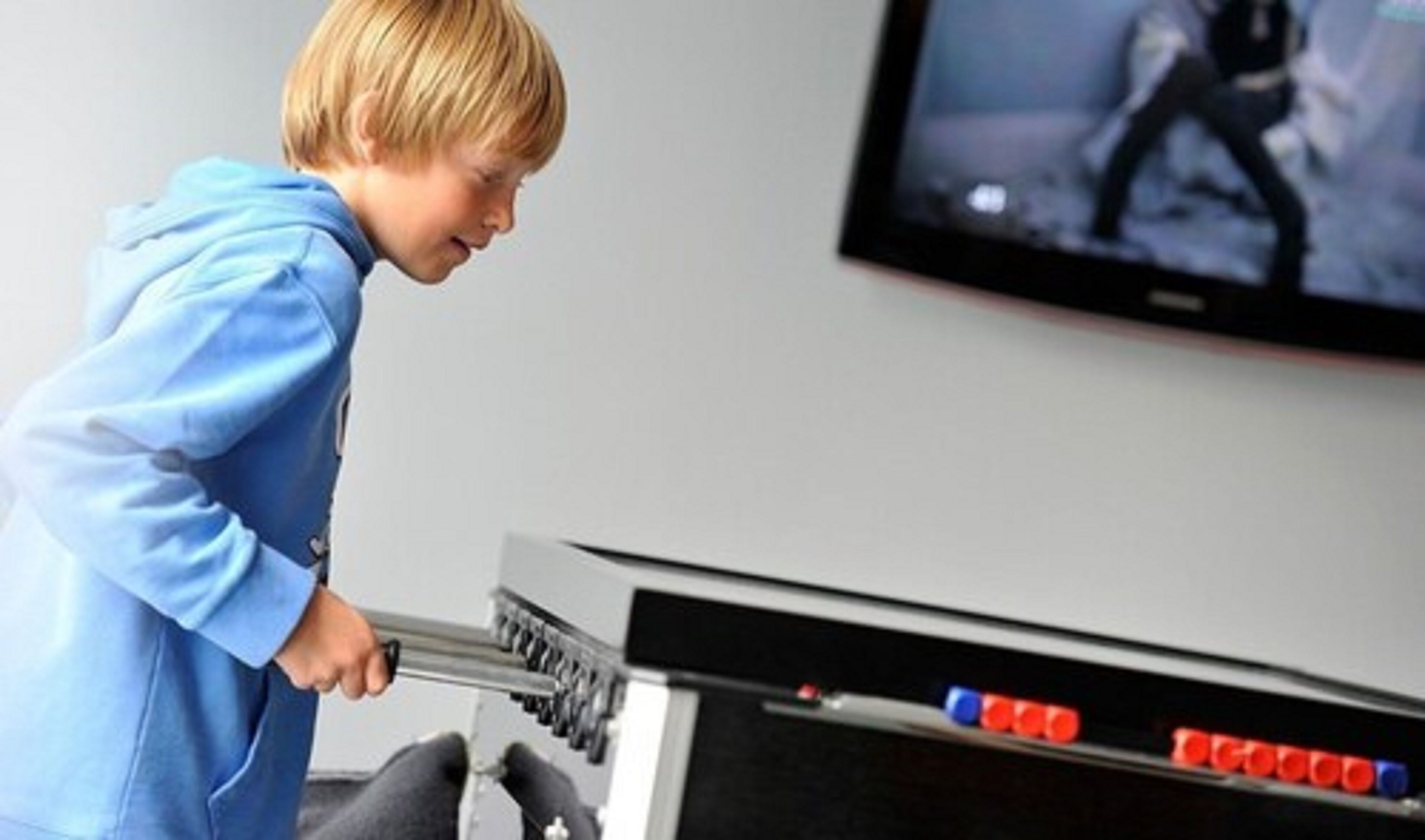 A child playing a video game in front of a television.