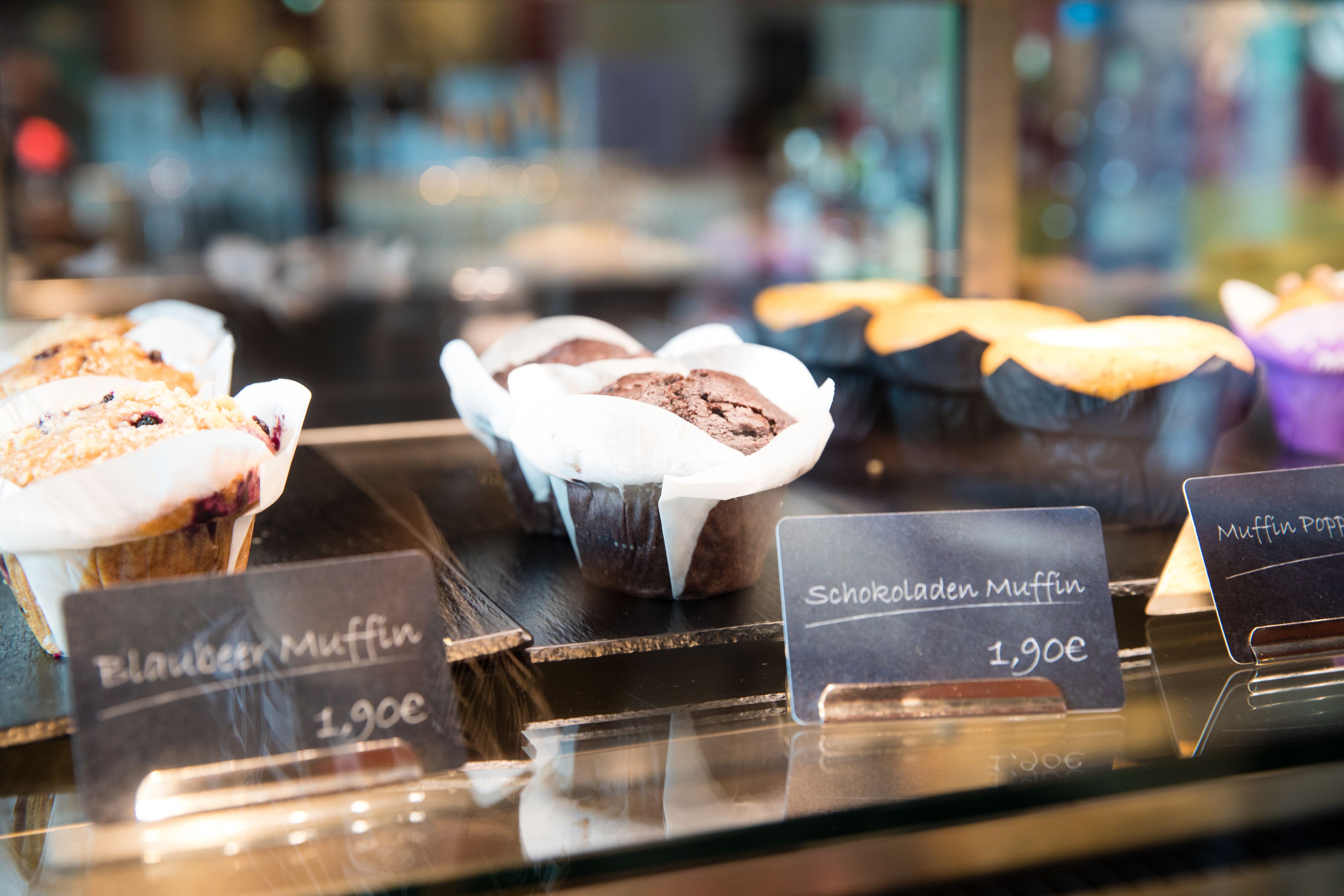 Leipomon vitriinissä on esillä erilaisia muffinseja ja kuppikakkuja, ja niissä on etiketit, joissa lukee muun muassa ”Blauer Muffin” ja ”Schokoladen Muffin”.