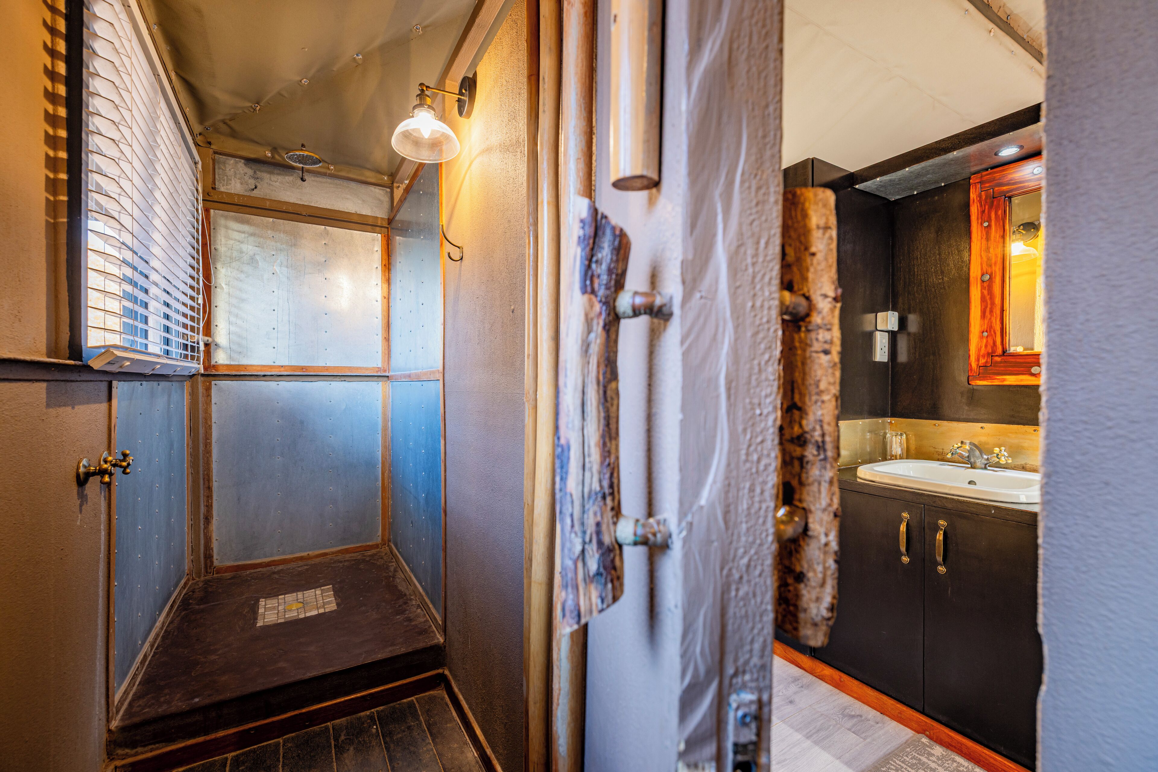 A bathroom with a shower, a sink, and a mirror.