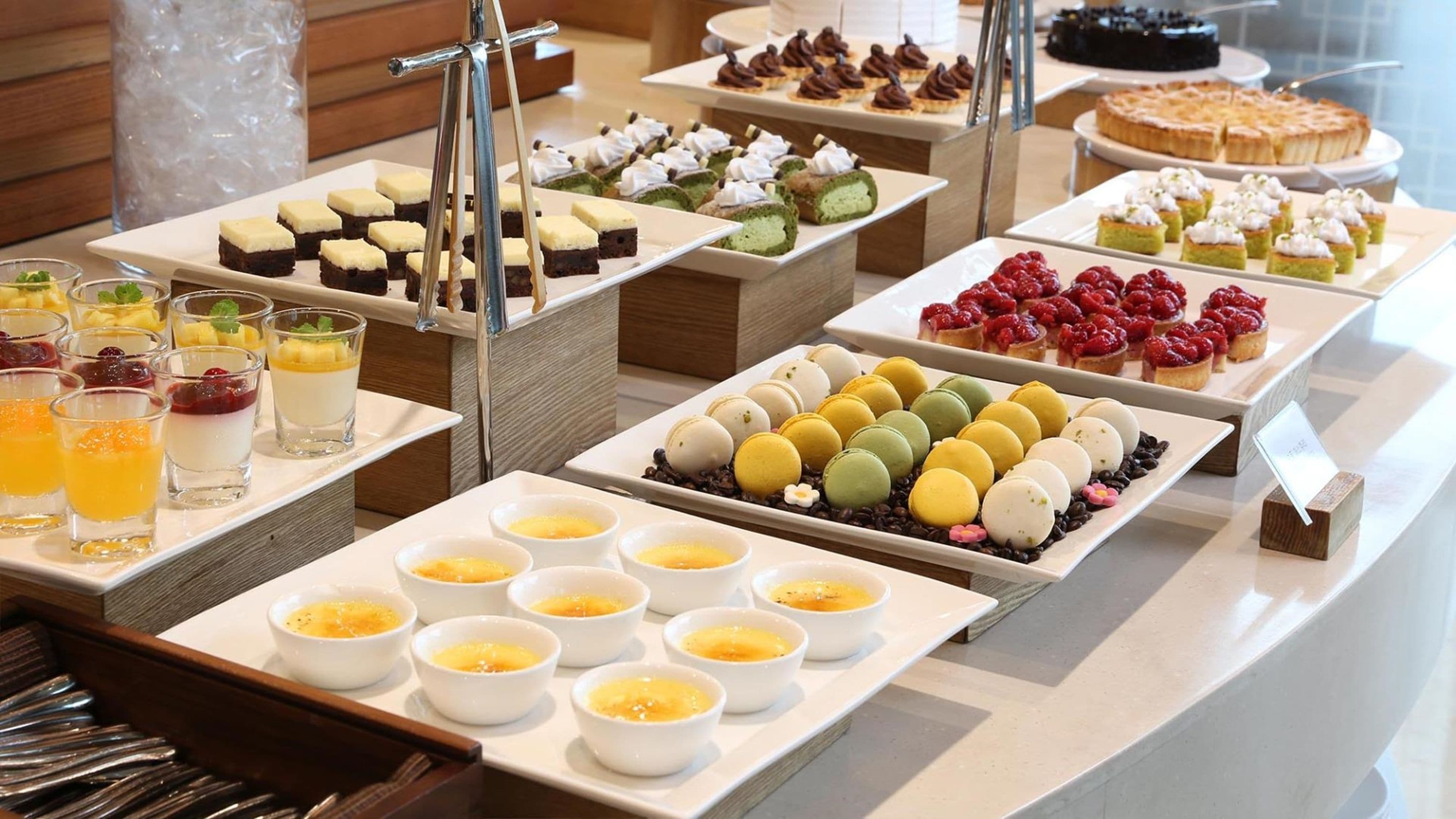 A buffet with various desserts and beverages.
