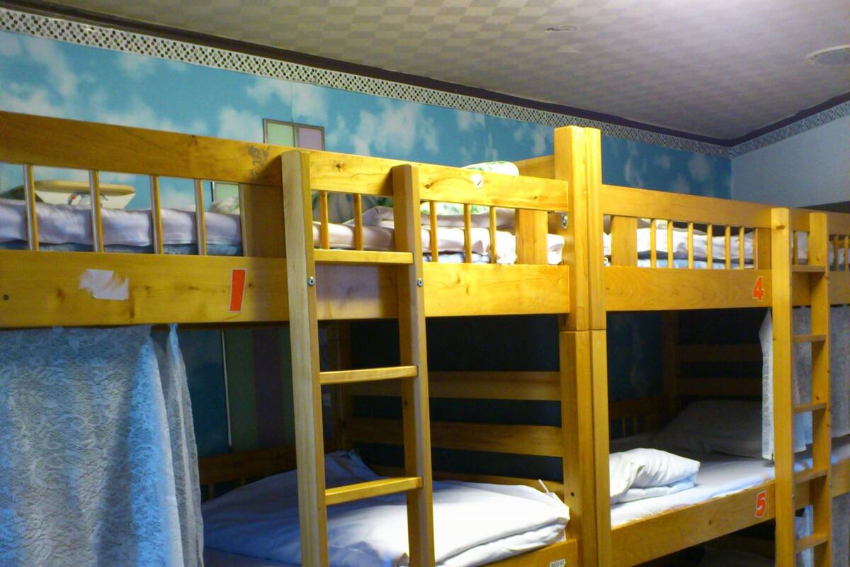 A room with bunk beds, each labeled with a number.