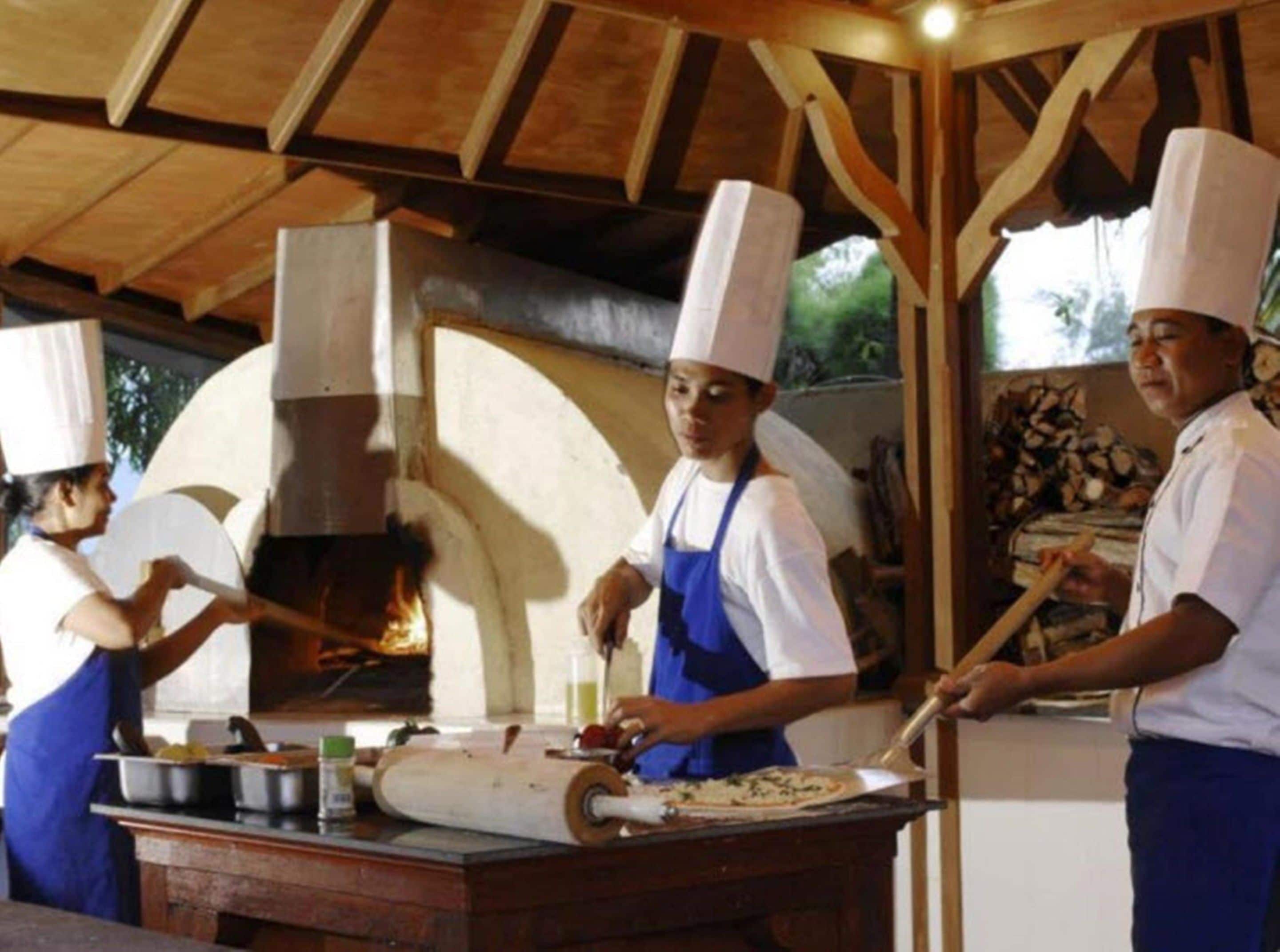 A traditional wood-fired oven in a rustic kitchen setting.