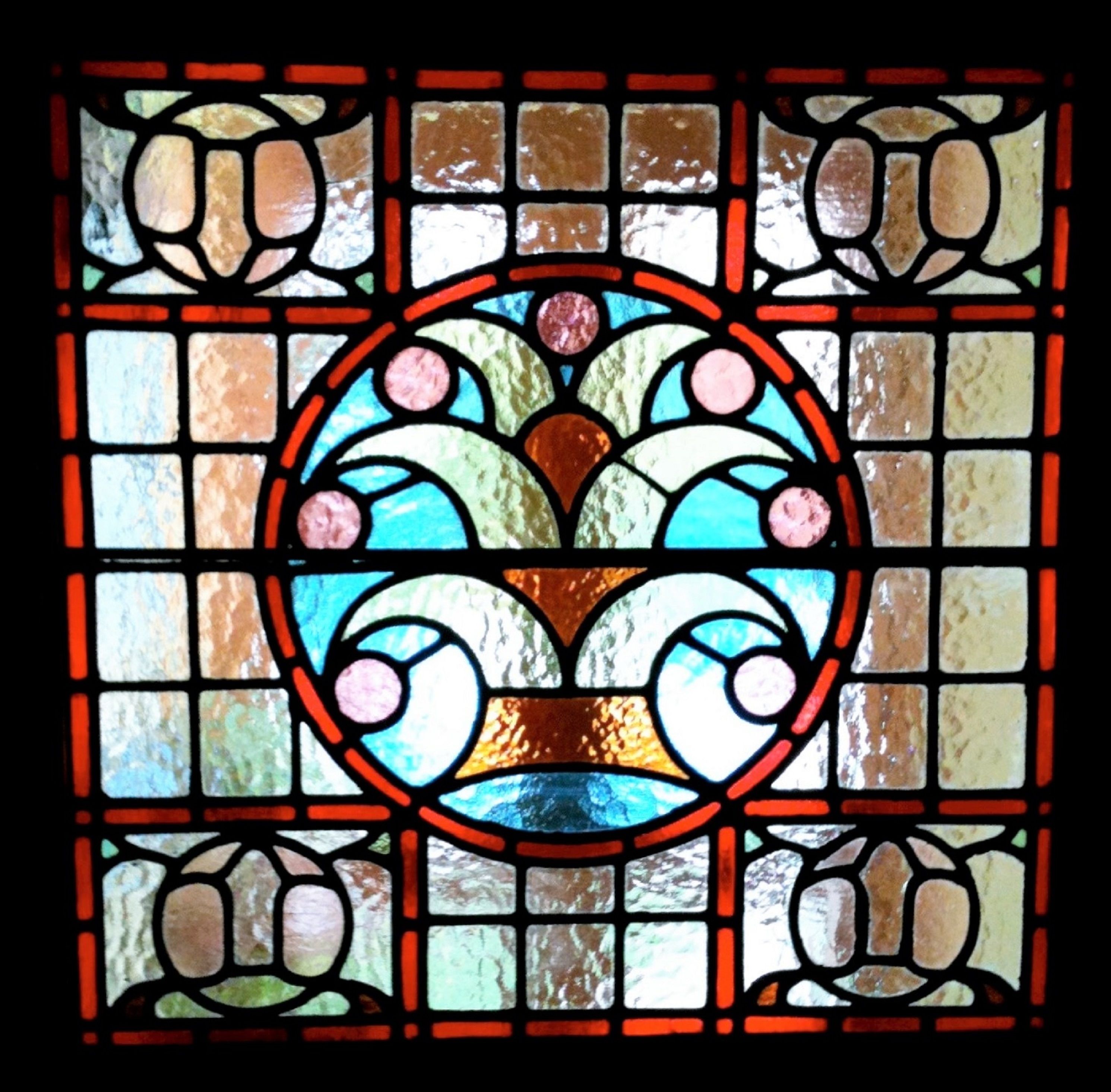 A stained glass window with a floral pattern.