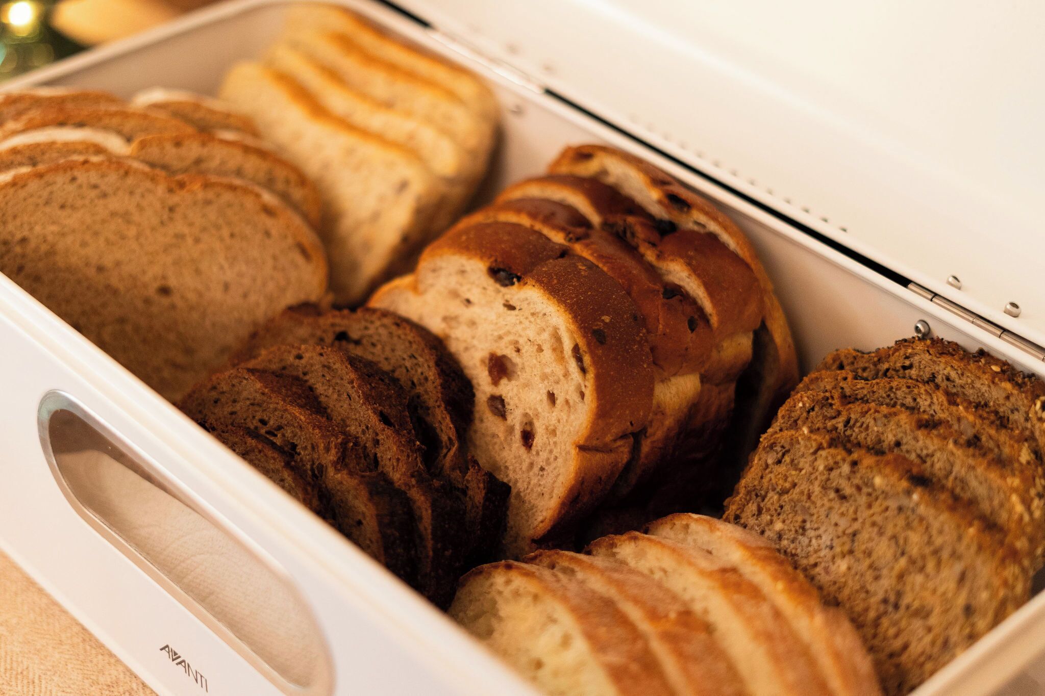 A loaf of bread in a white bread box.