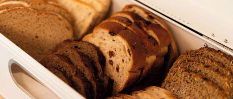 A loaf of bread in a white bread box.