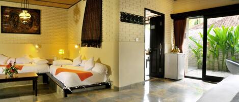 A hotel room with a bed, bedside tables, a desk, and a view of the outdoors.